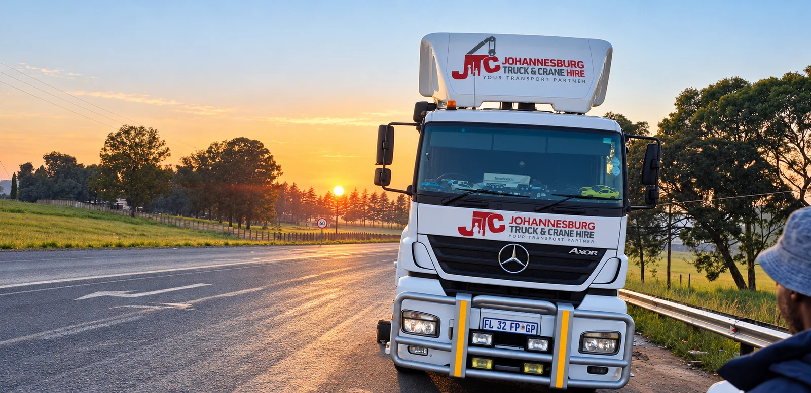Enhanced JTC branded Mercedes truck beside the road at sunrise