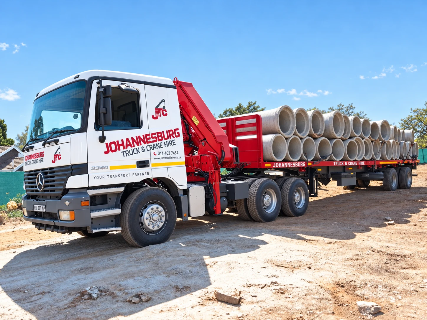 Enhanced JTC crane truck transporting concrete pipes