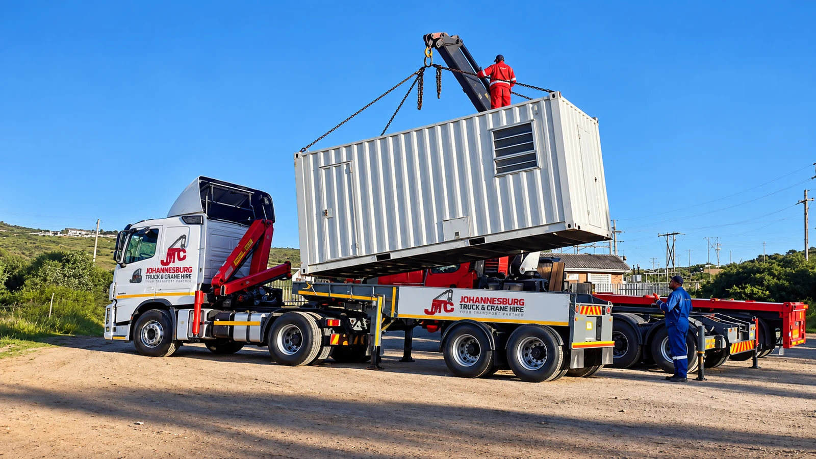 Enhanced JTC crane truck handling a shipping container