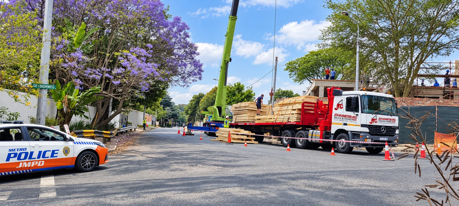 Enhanced JTC flatbed and mobile crane during a roadside lifting operation