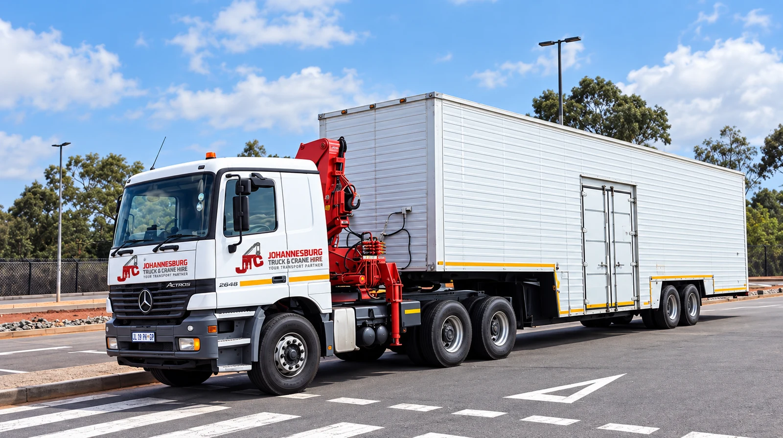 Enhanced JTC crane truck transporting a large enclosed load