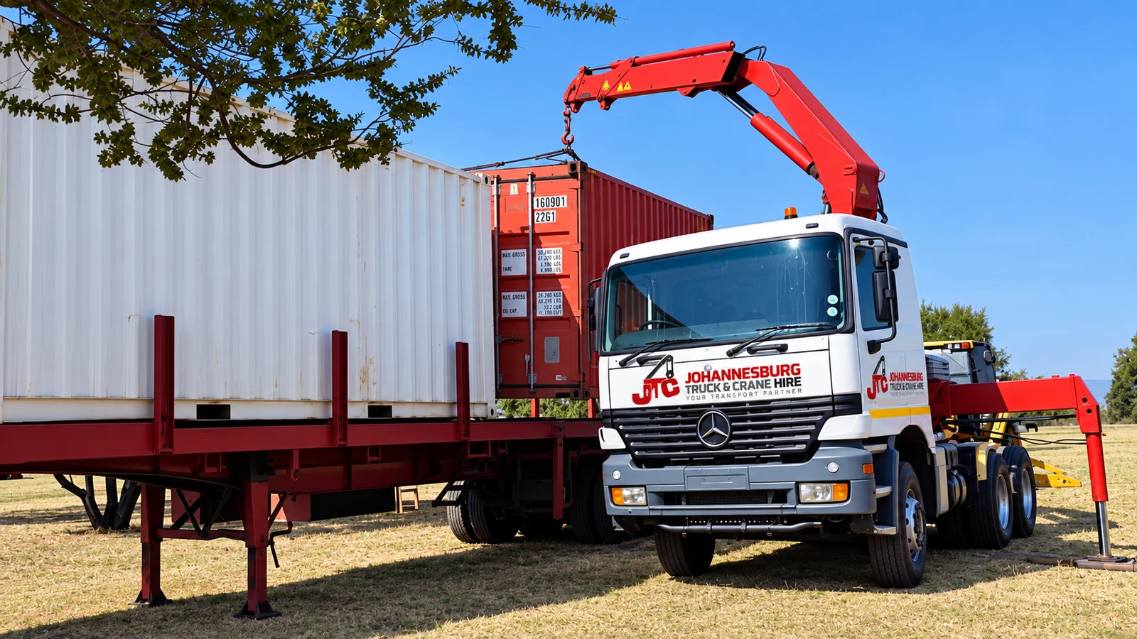 Enhanced JTC truck-mounted crane lifting a shipping container